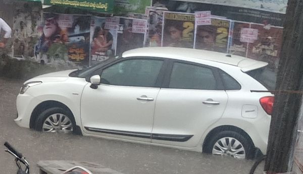 Negligence of highway officials... Car stuck in rainwater.