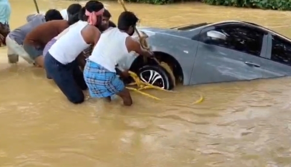 Car washed away by floodwaters; major tragedy averted.
