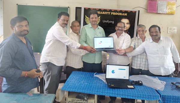 Handing over a laptop to Jallikommara High School