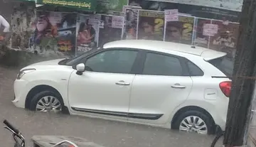 Negligence of highway officials... Car stuck in rainwater.