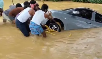 Car washed away by floodwaters; major tragedy averted.