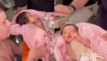 Hope sprouting amidst the ruins... an 18-day-old infant who conquered death.