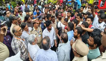 Tension at Andhra University – Students protest in the rain.