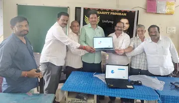 Handing over a laptop to Jallikommara High School